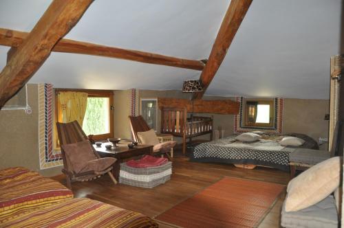 a living room with a bedroom and a bed and a room with at La Source, Vegetarian Guest House in Chabeuil