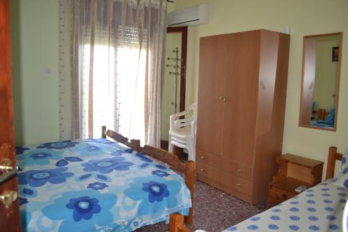 a bedroom with a bed and a chair and a window at House Souzanna in Toroni