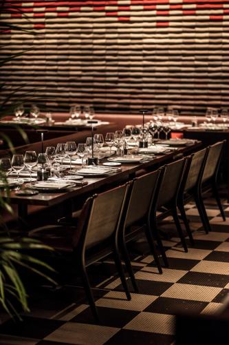 a long table with chairs and wine glasses at Hotel Les Bains Paris in Paris