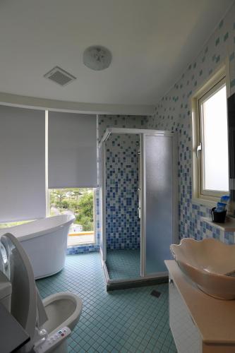 a bathroom with a shower and a tub and a sink at The Riverview Retreats in Wujie
