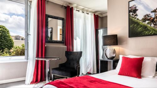 a bedroom with a bed and a window with red curtains at Hotel l'Avenue in Chantilly