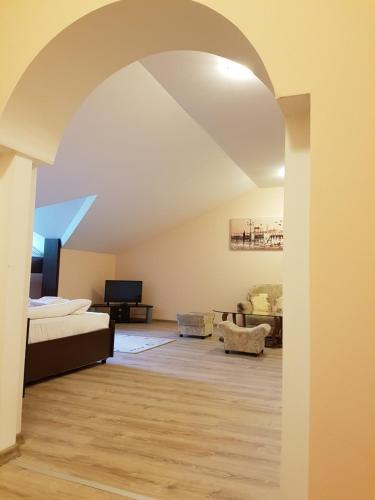 a living room with an archway and a couch at Hotel Panorama in Panichishte