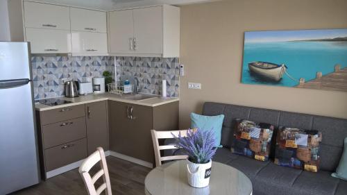 a kitchen with a couch and a table in a room at Haraki Beach in Haraki