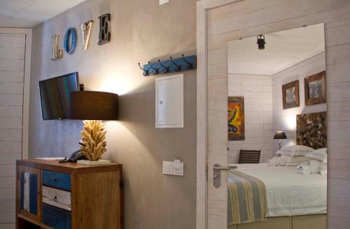 a bedroom with a bed and a door with a mirror at Surfers Lodge Peniche in Peniche