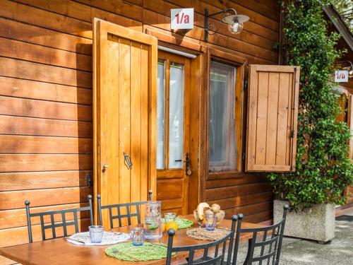 a table with two chairs sitting in front of a house at Green Village Assisi in Assisi