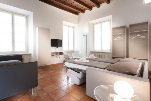 a room with four beds and a television in it at Casa Alla Lega in Arco
