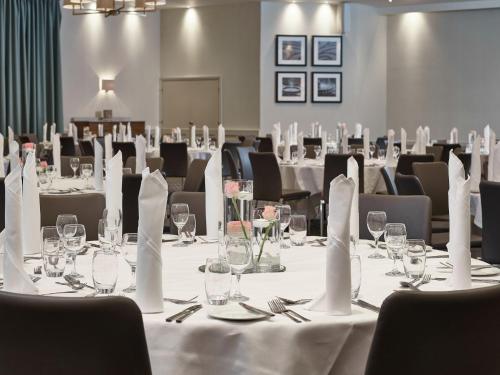 a conference room with white tables and chairs at Staverton Park Hotel & Golf Club in Daventry