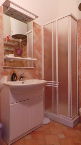 y baño con lavabo y ducha. en Residence Sottomonte, en Golfo Aranci