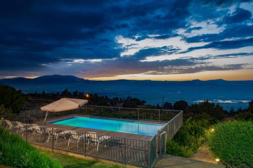 a view of a swimming pool at night at Vibe Naftali Estate in Ramot Naftali