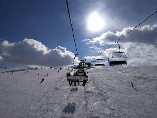 a group of people riding a ski lift in the snow at Kompleks Zagroń Istebna in Istebna