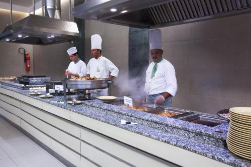 a group of chefs preparing food in a kitchen at Seabel Alhambra Beach Golf & Spa in Port El Kantaoui