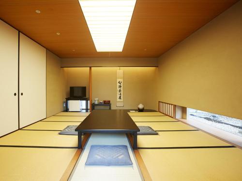 a conference room with a table in the middle at Osaka Academia in Osaka