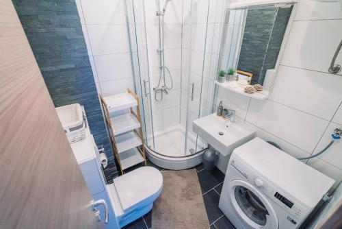 a bathroom with a toilet sink and a shower at Apartmani Josip in Podstrana