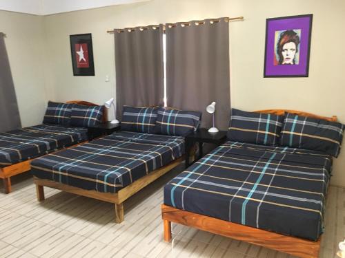 a living room with two beds and a couch at Stardust Beach Hotel in Lian