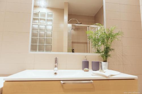 a bathroom with a sink and a mirror at we saw athens in Athens