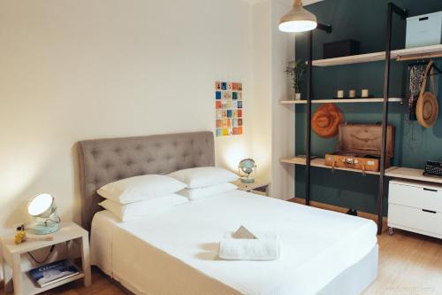 a bedroom with a white bed and a green wall at we saw athens in Athens