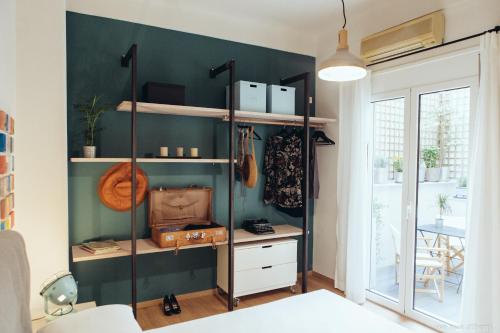 a room with a green wall with shelves at we saw athens in Athens