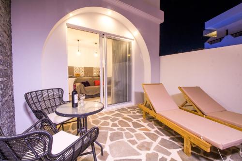 a room with a table and chairs and a table and chairs and a table at Alexander Studios & Suites - Adults Only in Faliraki