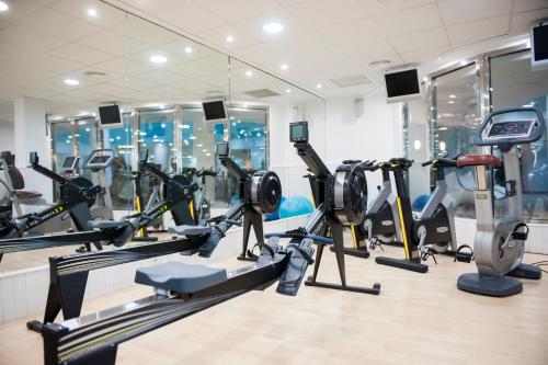 a gym with treadmills and elliptical machines at Oliva Nova Beach & Golf Hotel in Oliva