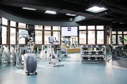a gym with treadmills and cardio equipment in a building at Metropark Hotel Mongkok in Hong Kong