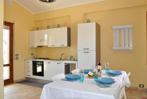 a kitchen with a table with blue dishes on it at Casa vacanza Nocellara in Menfi