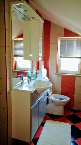 a bathroom with a sink and a toilet at Apartman Dadić in Malinska