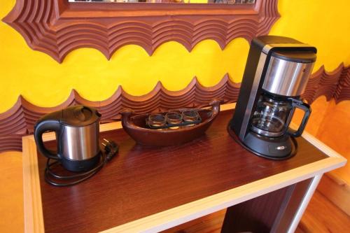 a coffee maker and kettle on a wooden table at Guest House Unika in Tryavna