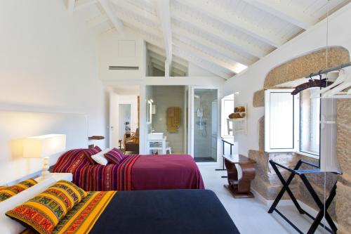 a bedroom with two beds and a television in it at Quinta De Fundevila -quinta privada in Cabeceiras de Basto