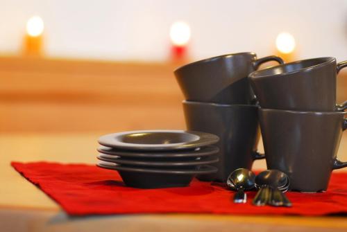 a group of black cups and spoons on a table at Alpenchalet Brücke in Mayrhofen