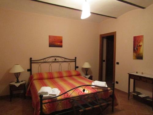 a bedroom with a bed with a orange bedspread at B&B La Gibiana in Costigliole dʼAsti