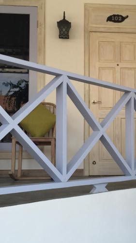 a wooden fence with a chair in front of a door at BC Summer Beach in Pran Buri