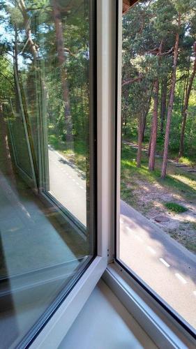 a window in a room with a view of a road at Apartamentai Nidoje in Nida