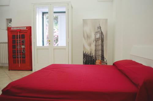 アヴェトラーナにあるWhite Salentoの赤いベッドと赤い電話ブース付きのベッドルーム1室