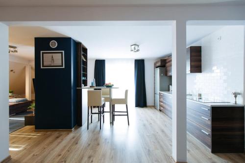 eine Küche und ein Wohnzimmer mit Tisch und Stühlen in der Unterkunft Villa Dune in Sarbinowo