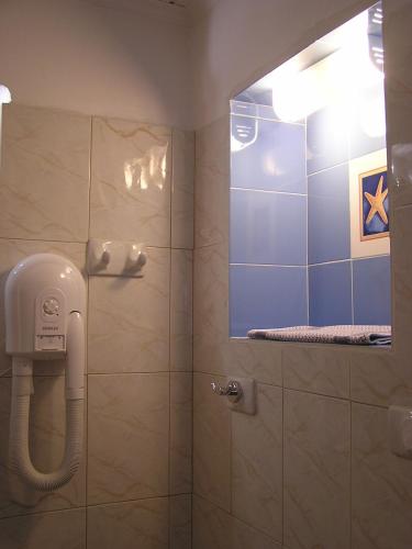 a shower with a phone in a bathroom at Eolos Apartments with Private Parking in Agios Nikitas