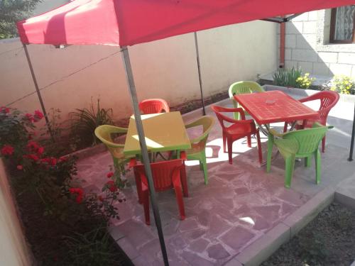 a group of tables and chairs under an umbrella at Light House Old City in Akhaltsikhe