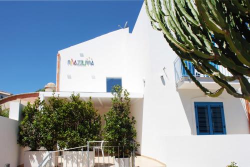 a large white building with a large window at Rivazzurra Design Rooms in San Vito lo Capo