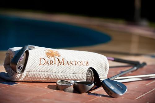 a towel with a drink marriot and a pair of spoons at Dar Maktoub in Agadir
