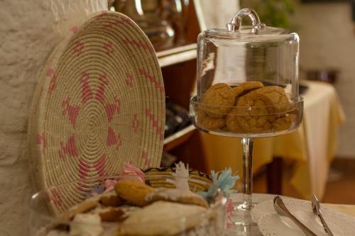 a bowl of cookies sitting next to a glass container at Sa Pedrera Country Hotel in Càbras