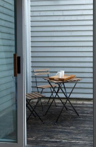 a table and two chairs sitting on a porch at Mountain Side Condo Loft at The Blue Mountains in Blue Mountains