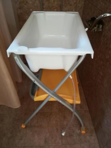 a white sink sitting on a stand in a bathroom at Nikoloudi Estate in Agios Nikolaos