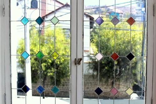 a window with colorful glass blocks on it at Casa Fusion Hotel Boutique in La Paz