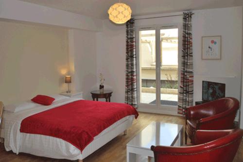 a bedroom with a bed and a table and chairs at Hôtel Restaurant Maison Blanche in Rungis
