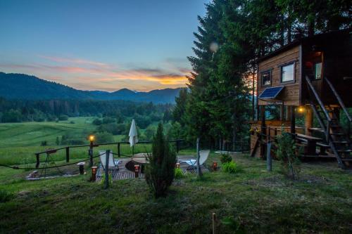 a cabin in the woods with a view of the mountains at Tree House Gorski Lazi in Tršće