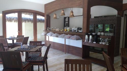 a restaurant with a table and chairs and a bar at Hotel Sao Francisco in Jericoacoara
