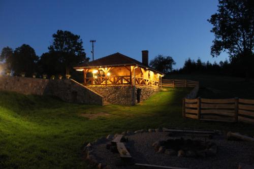 a gazebo with lights in a field at night at Osada Ulnowo - Holliday & Party House in Grunwald