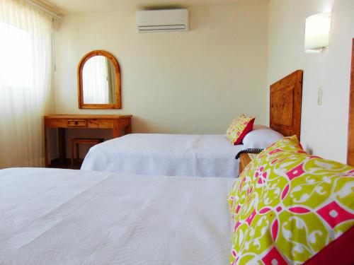 Ένα ή περισσότερα κρεβάτια σε δωμάτιο στο Hotel El Pescador