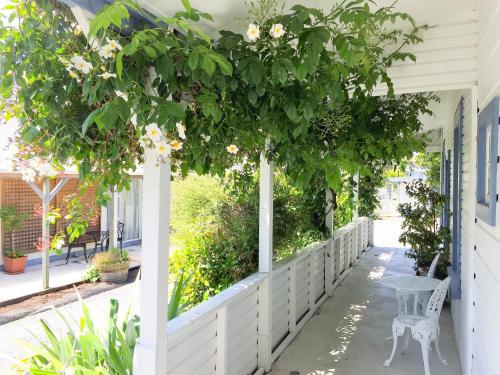 a pergola with white flowers on a house at Tongariro Crossing Lodge in National Park