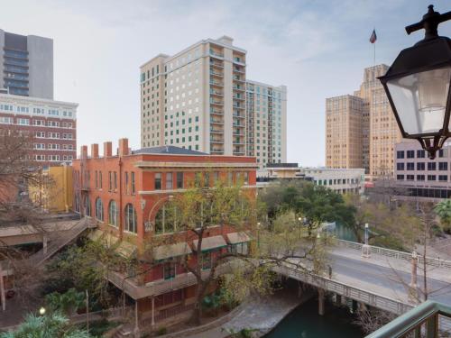 a view of a city with a bridge and buildings at Hotel Valencia Riverwalk in San Antonio