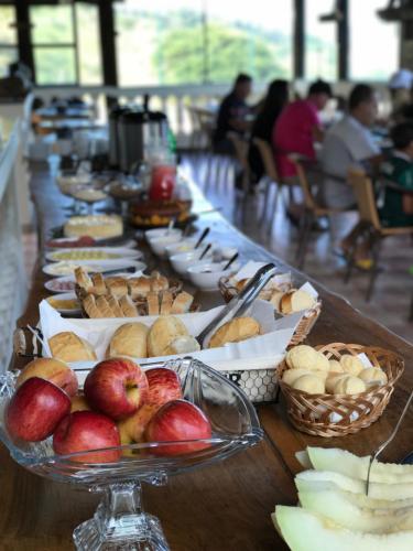 a long table with plates of food on it at Fazenda Mantiqueira e Restaurante in Camanducaia